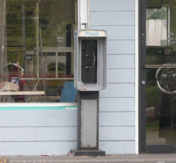 Empty pay phone stand at the laundromat