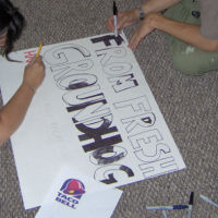 Mr. & Mrs. Spessa coloring the sign